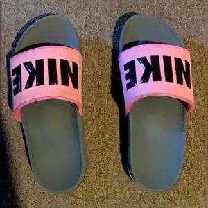 Pink Nike slides .